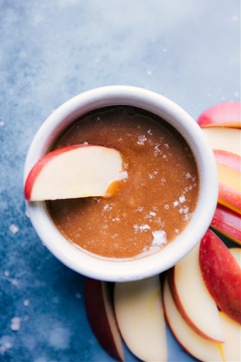 An apple slice dipped in Healthy Caramel Sauce