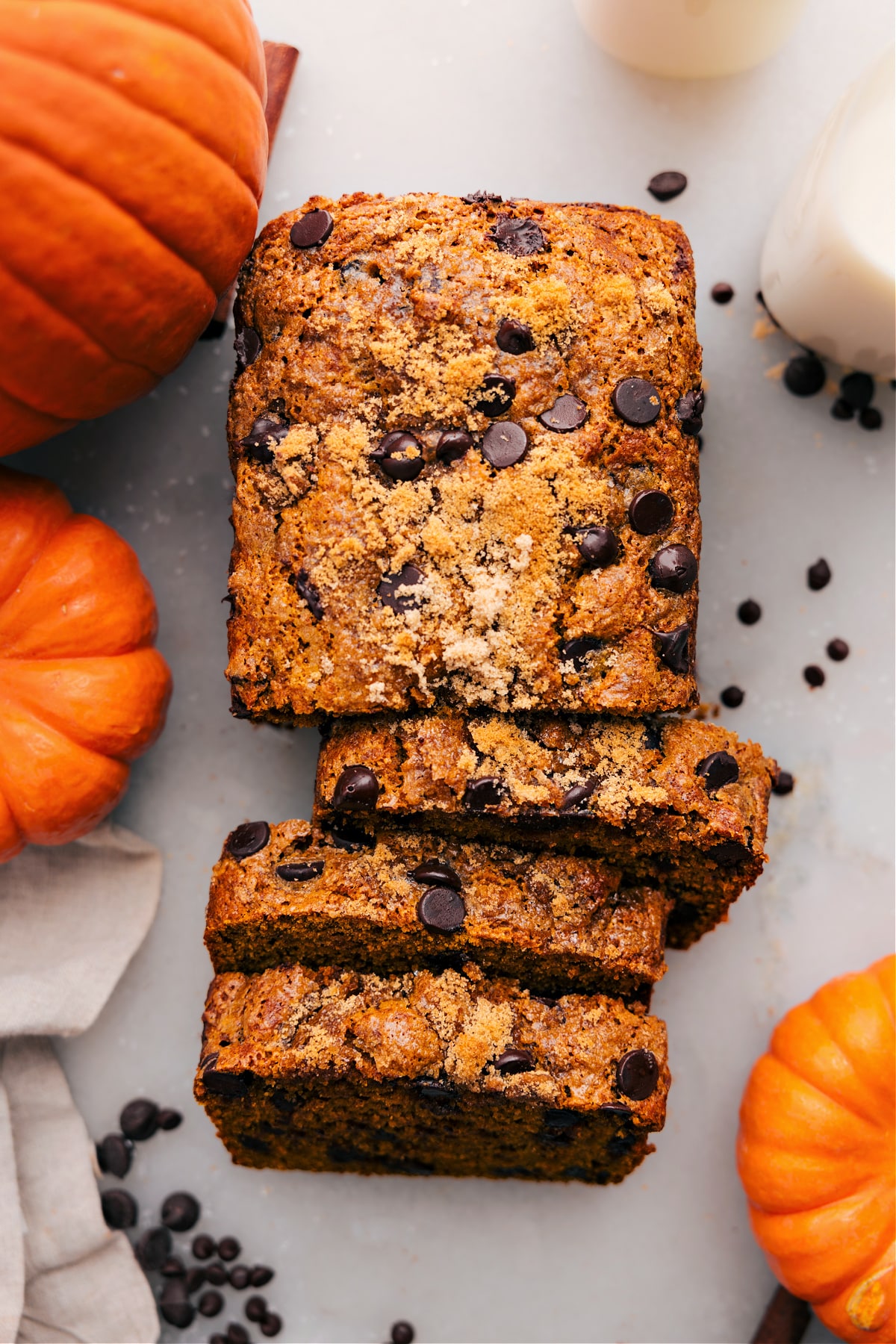 A loaf of moist pumpkin bread with a rich orange color, sliced and ready to enjoy.