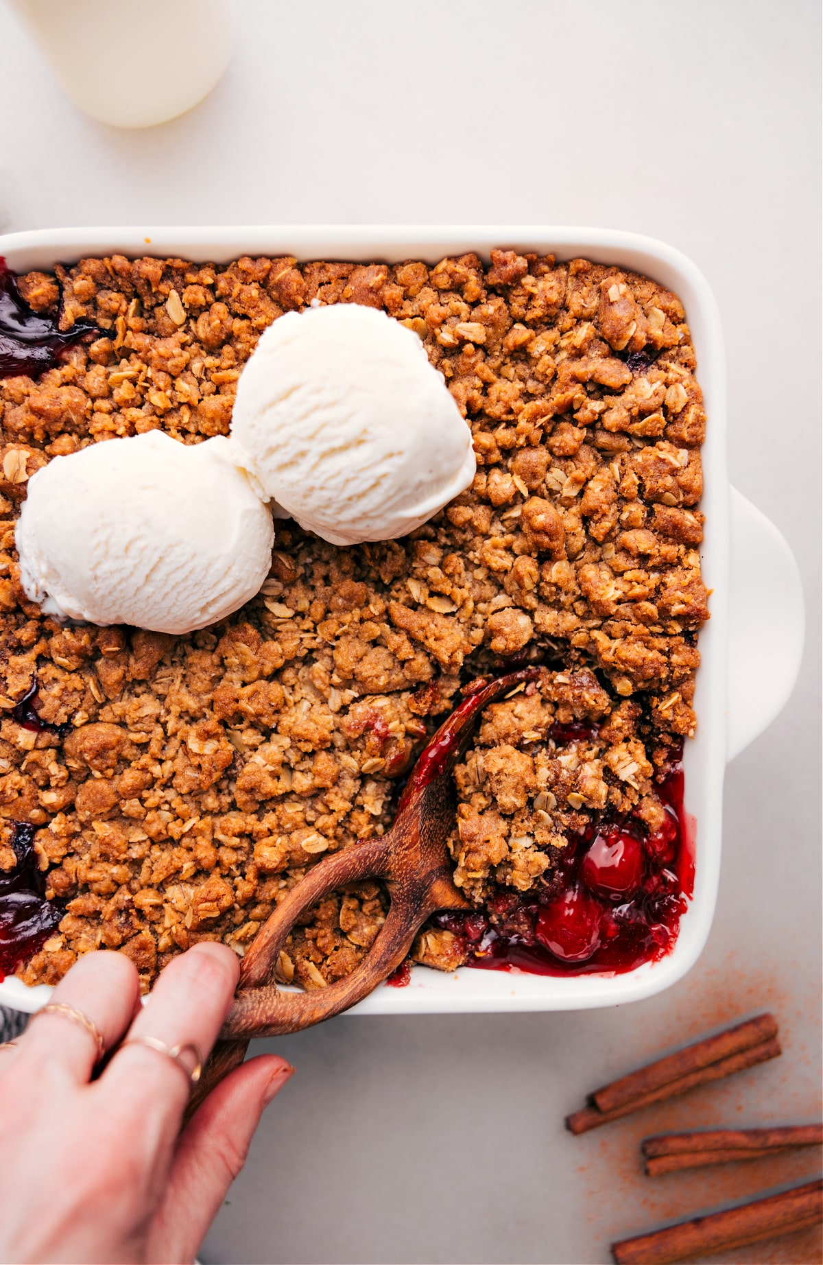 A wooden spoon poised to scoop a portion of the delicious dessert.