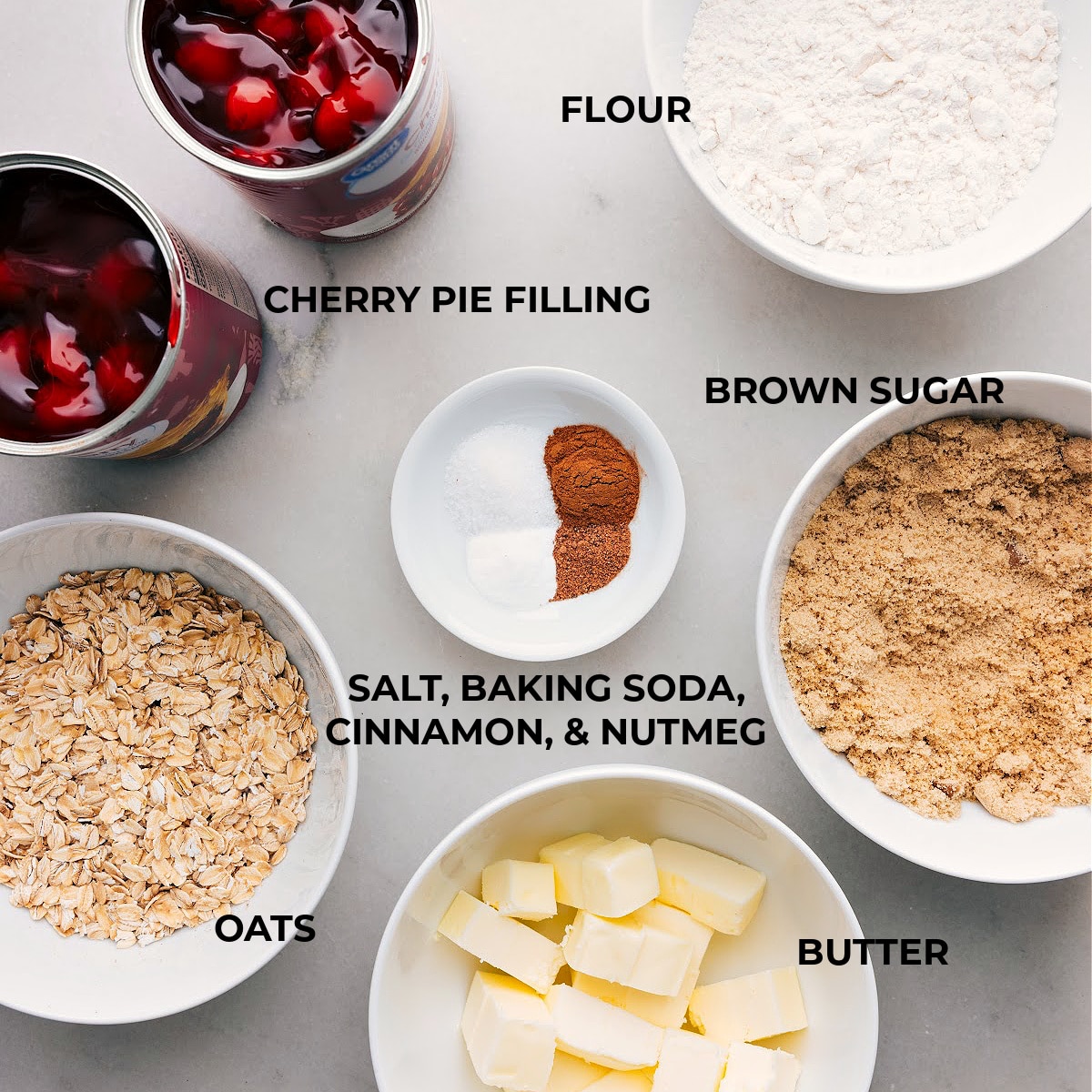 Ingredients used for the dessert, featuring cherries, oats, sugar, and more.