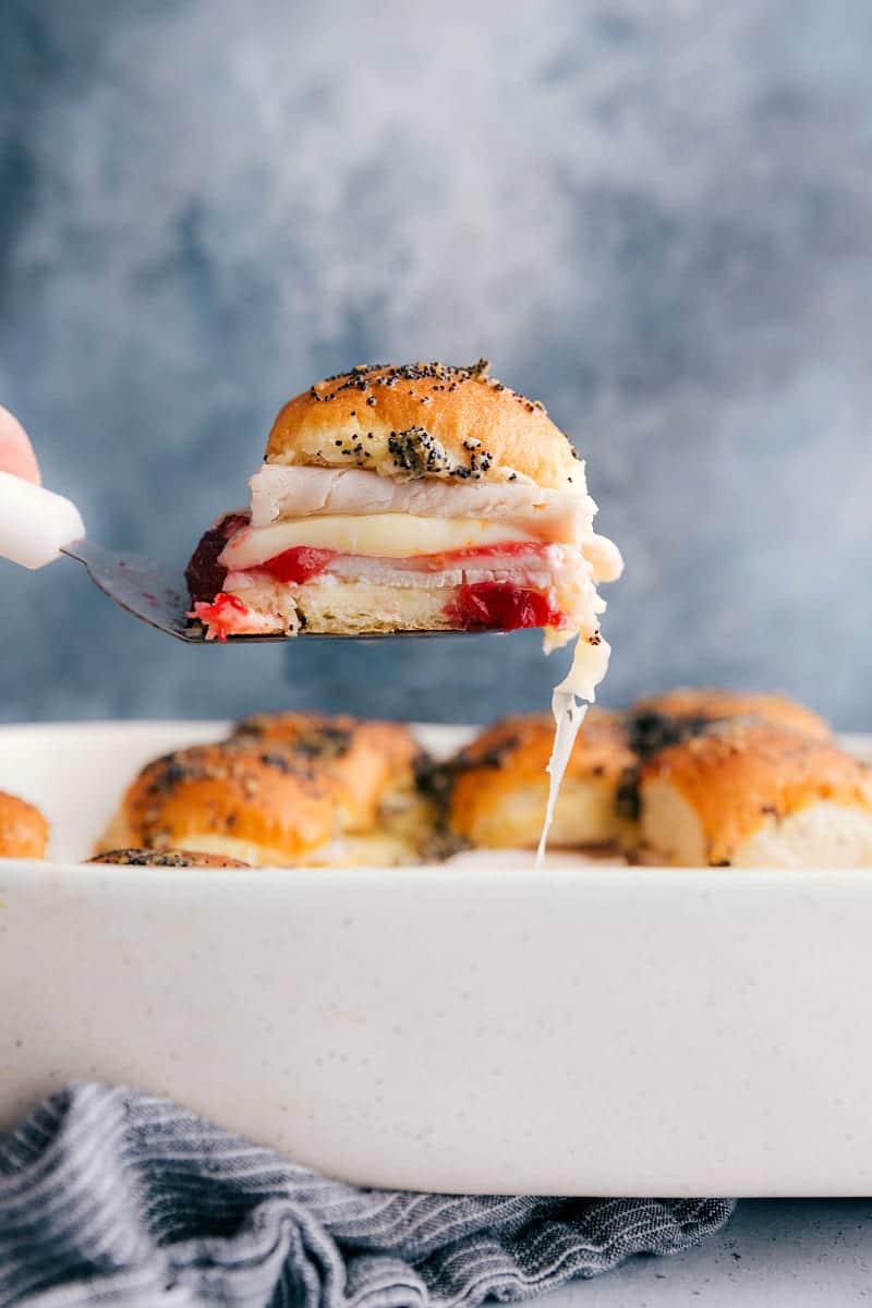 An up close shot of a turkey slider being pulled from the casserole dish: one of many leftover turkey recipes