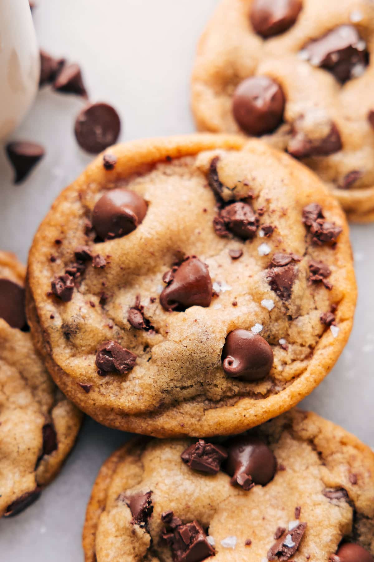 Finished coconut oil chocolate chip cookies with melting chips and a sprinkle of sea salt, tempting and ready to eat.