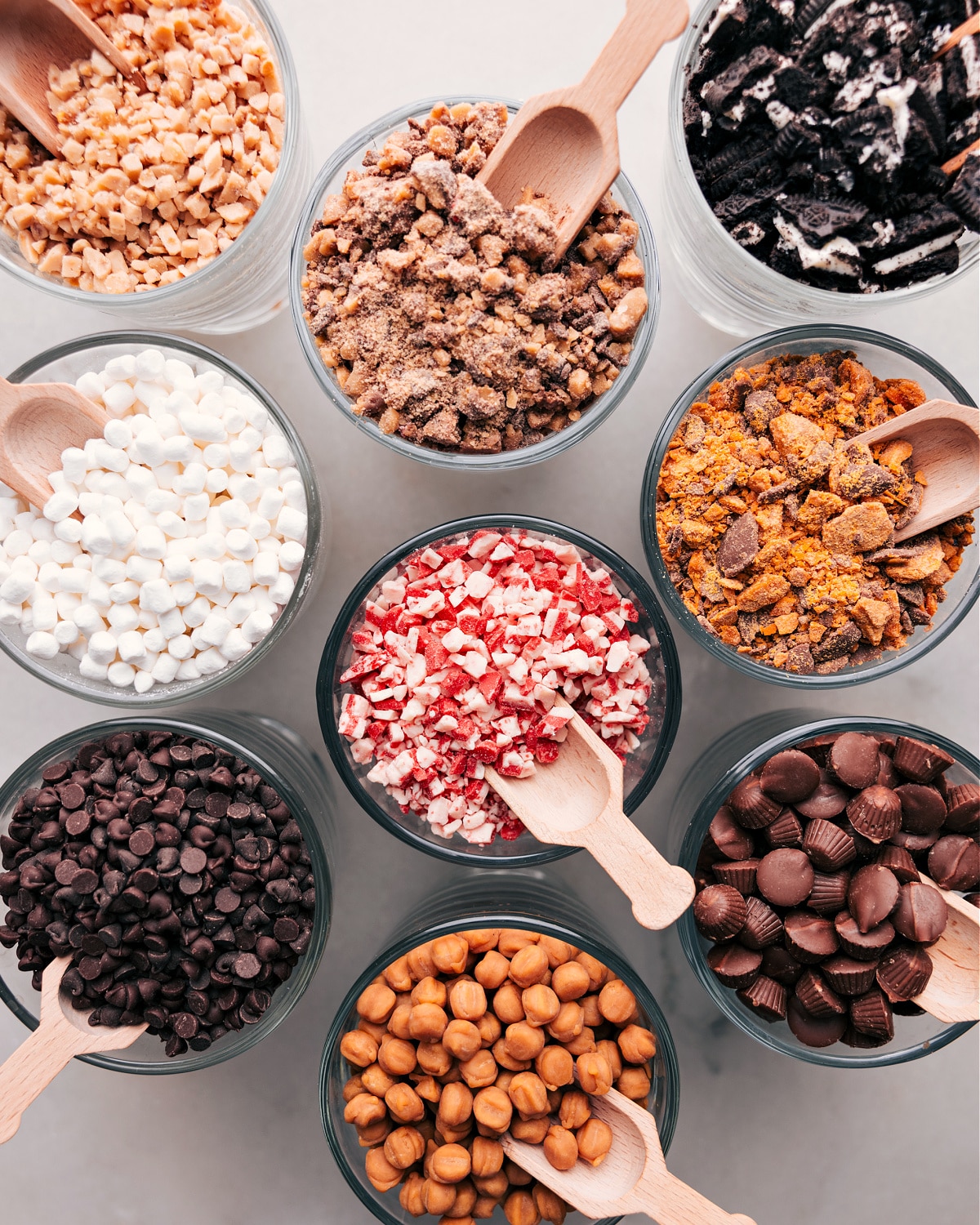 Assorted toppings elegantly presented in glass containers.