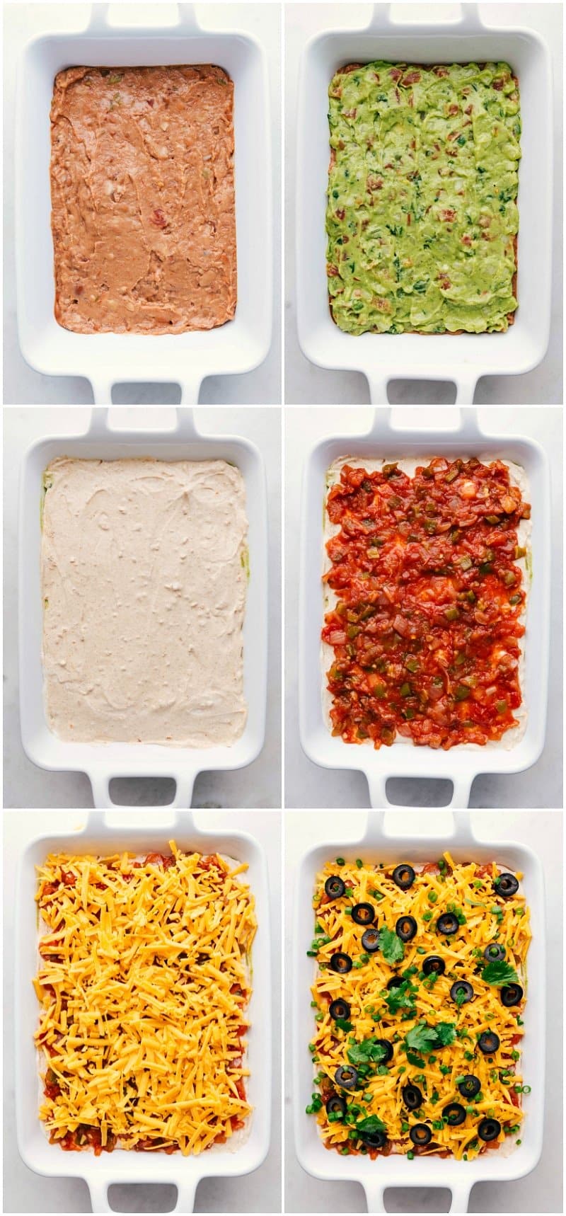 Overhead image showing the layers being built: refried beans, guacamole, sour cream with taco seasoning, salsa, cheese, olives, and green onion for this 7-Layer Bean Dip.