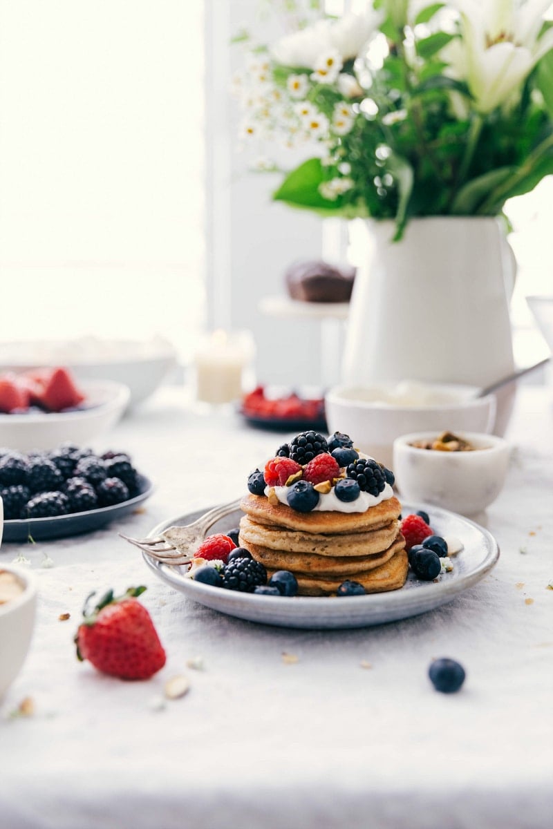 Image of the ready-to-eat Homemade Pancakes with whipped cream and fruit topping.