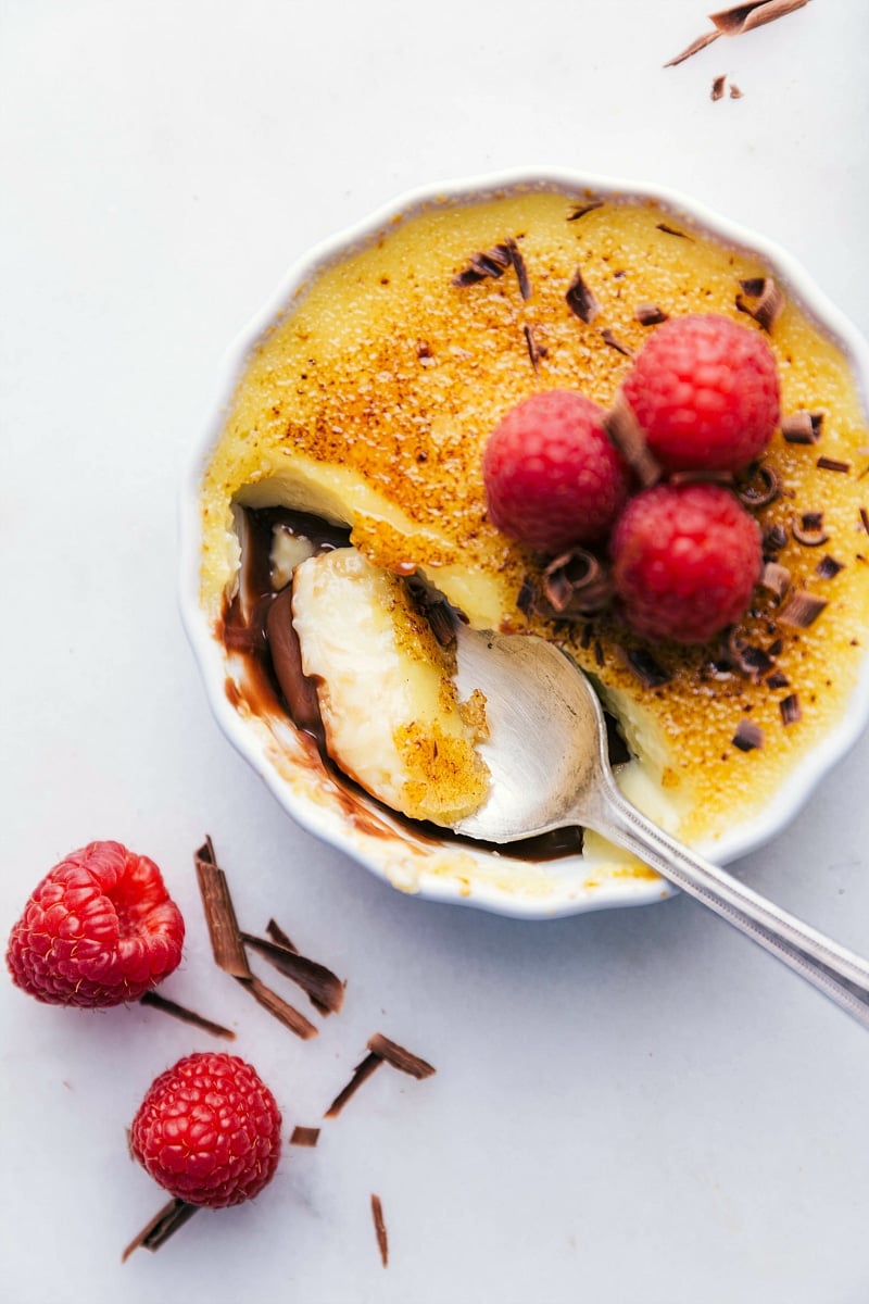 Image of a spoonful being taken out of these Tuxedo crèmes brûlée.