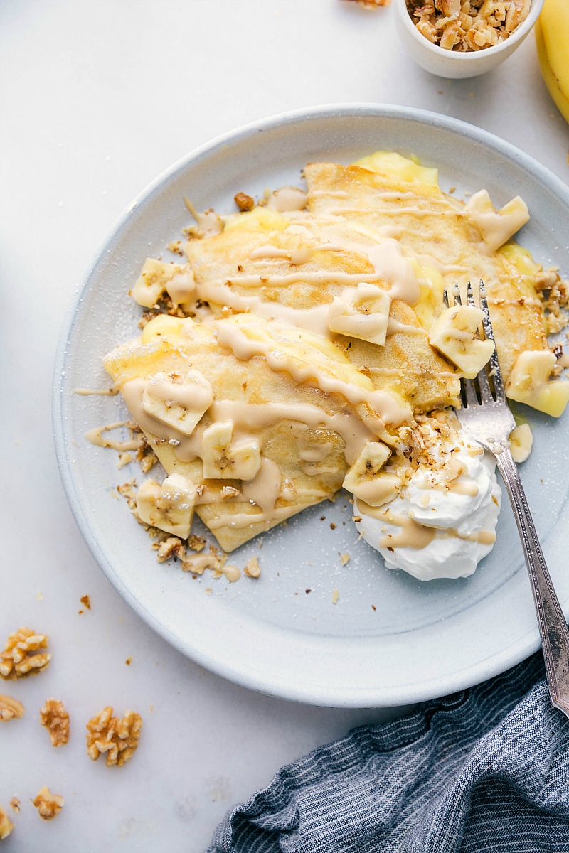 Overhead photo of a plate of Banana Crepes. Bananas are cut into heart shapes!