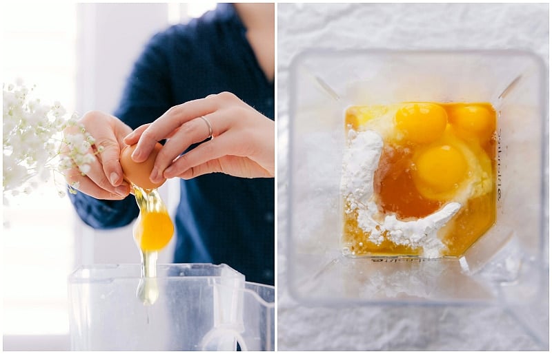 Breaking eggs into a blender, where other ingredients are already present, preparing for blending.