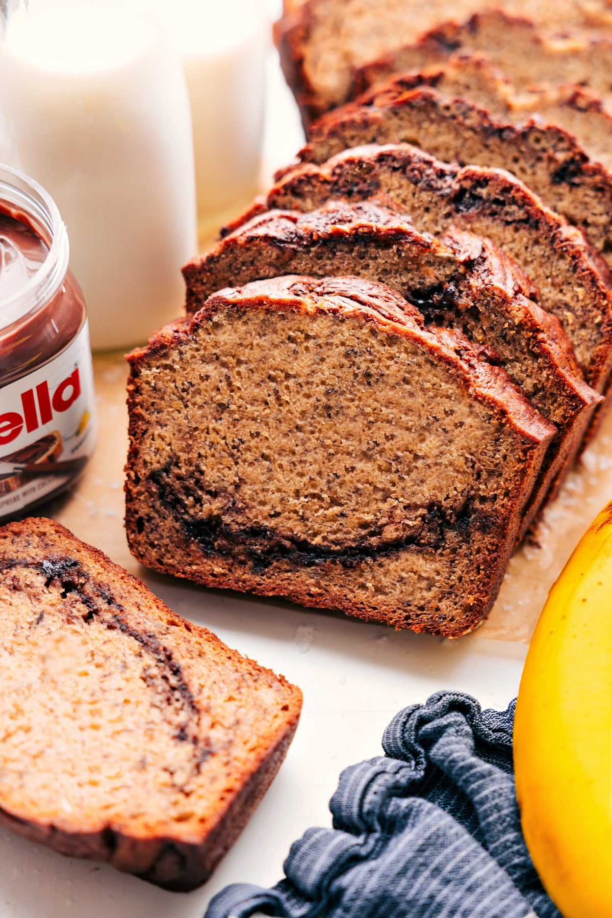 Super-moist banana bread swirled with Nutella and chocolate chips. Nutella Banana Bread is my all-time favorite sweet bread; it's flavorful and loaded with chocolate! Recipe via ChelseasMessyApron #breakfast #dessert #quick #easy #simple #best #chocolate #nutella #banana #bread #bananabread
