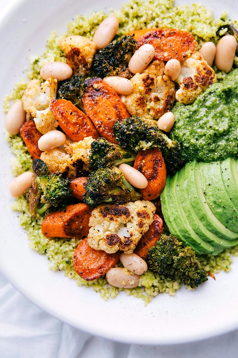 Overhead image of the Pesto Veggie Bowls ready to eat, with toppings added.