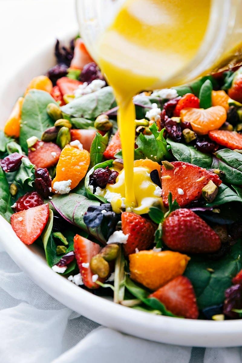 Image of the dressing being poured over the Strawberry Salad.