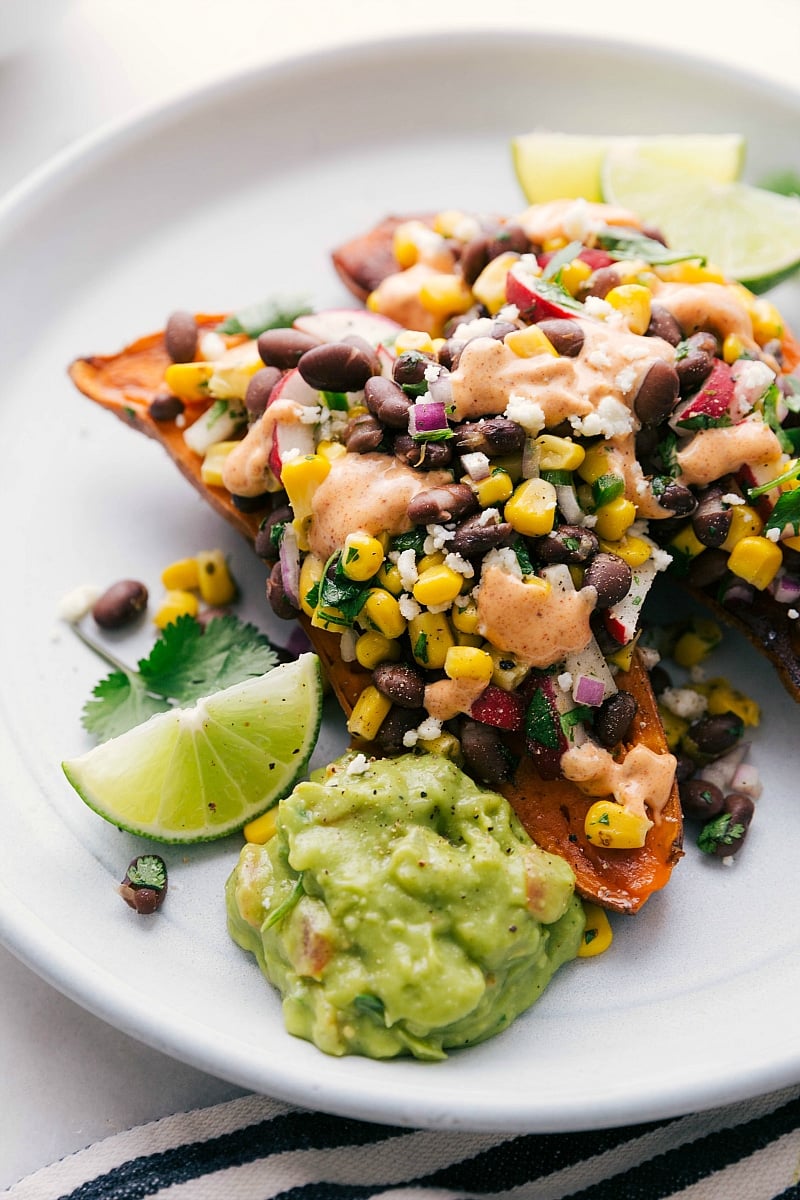 Shot of baked sweet potatoes covered in Southwestern topping.