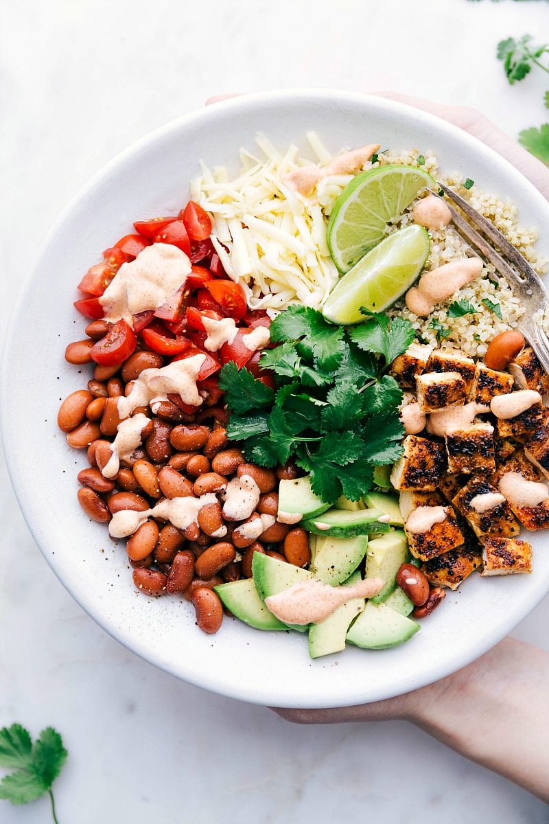 Overhead photo of a Burrito Bowl with sauce and all the toppings!