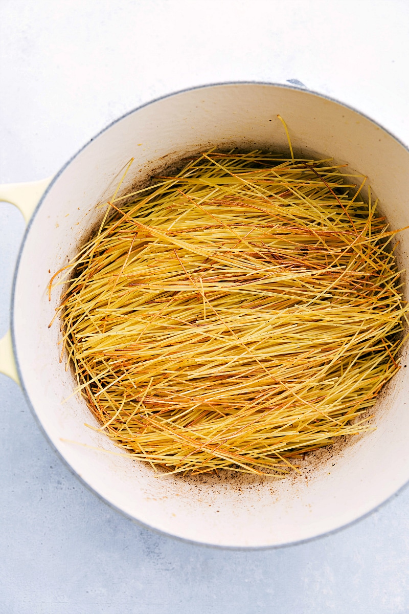 Toasted angel hair pasta in a pot.