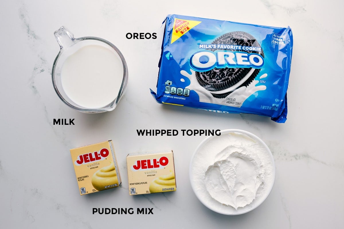 Ingredients prepped for easy assembly, including Oreos, milk, whipped topping, and pudding mix.