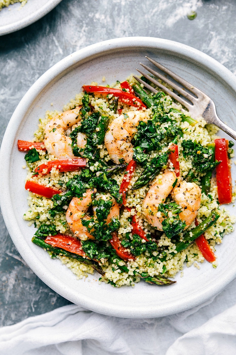 Overhead photo of finished Shrimp Couscous bowls with fork on the side.