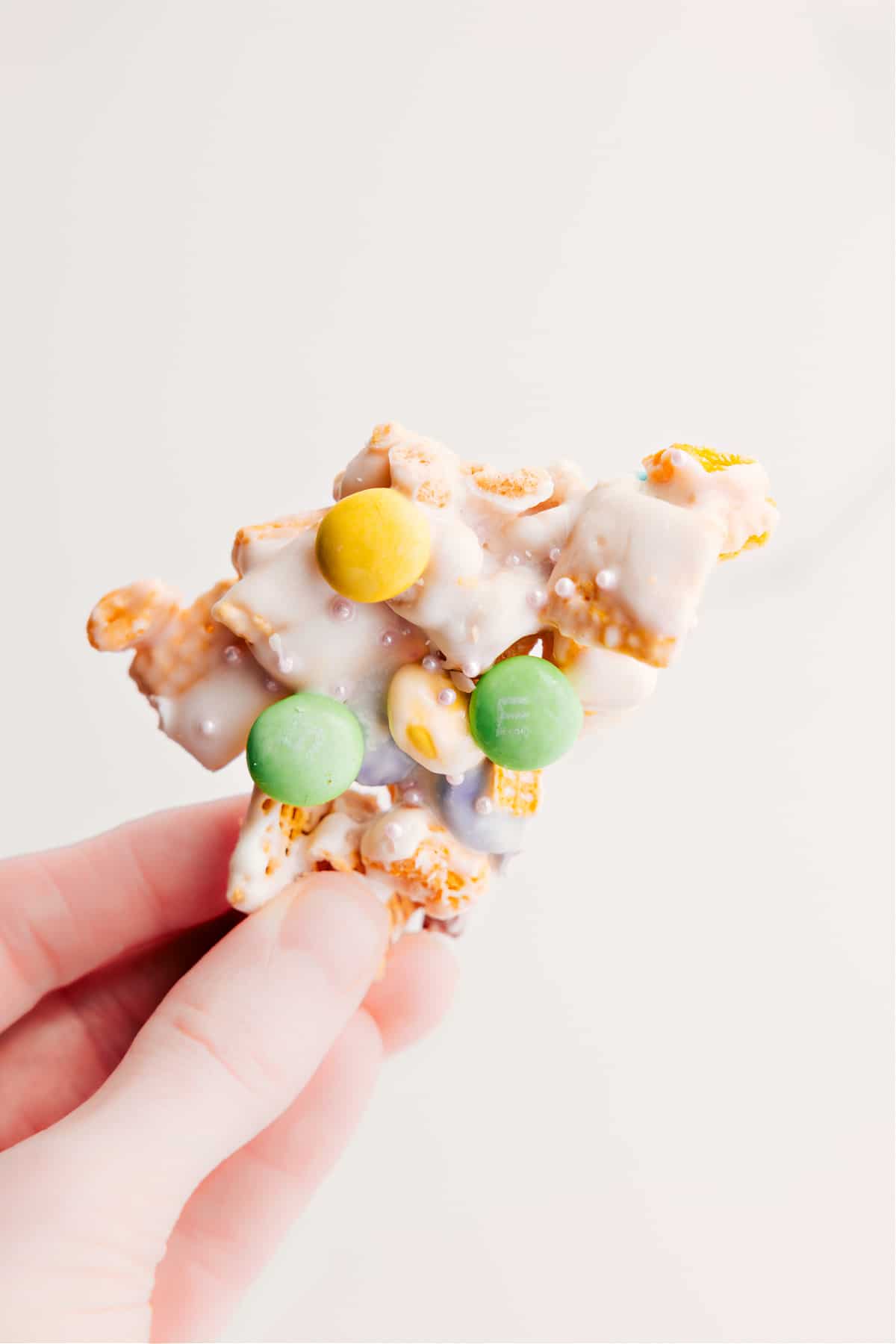 Holding up a piece, ready to enjoy this sweet treat.