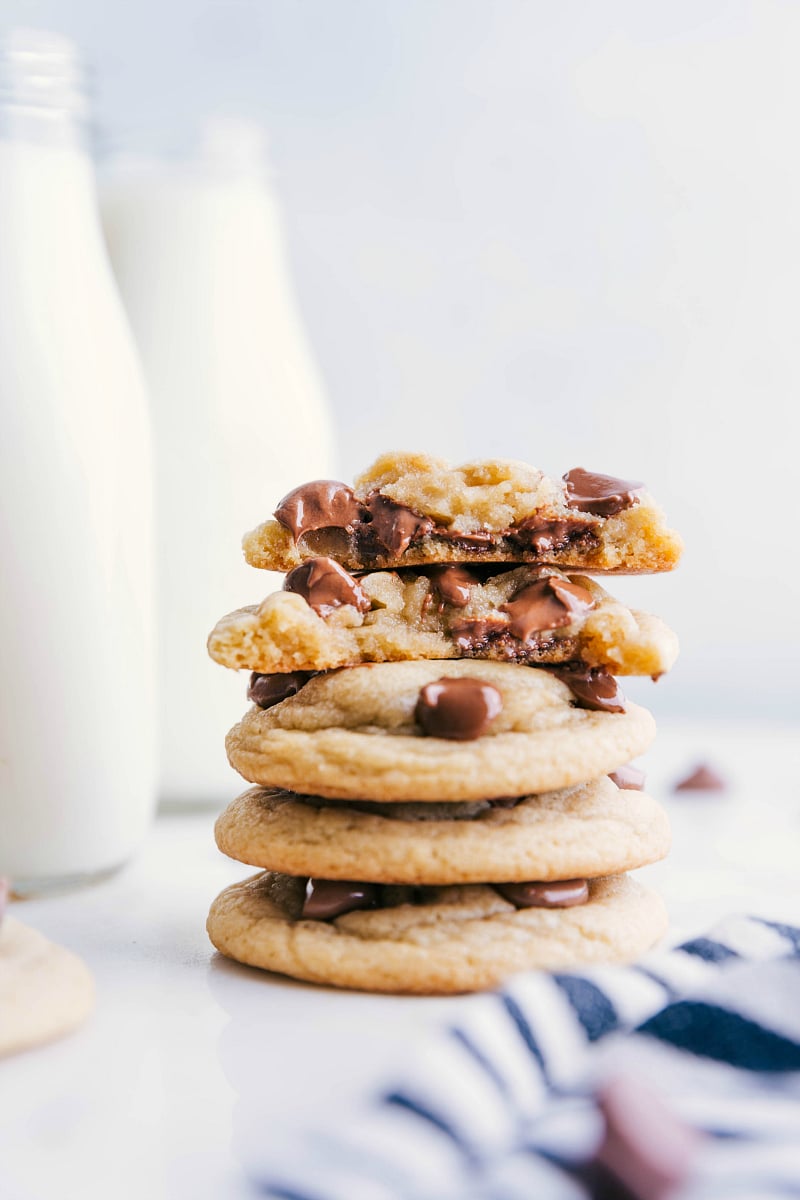 Stack of Chewy Chocolate Chip Cookies with one cookie broken in half to show the chewy center.