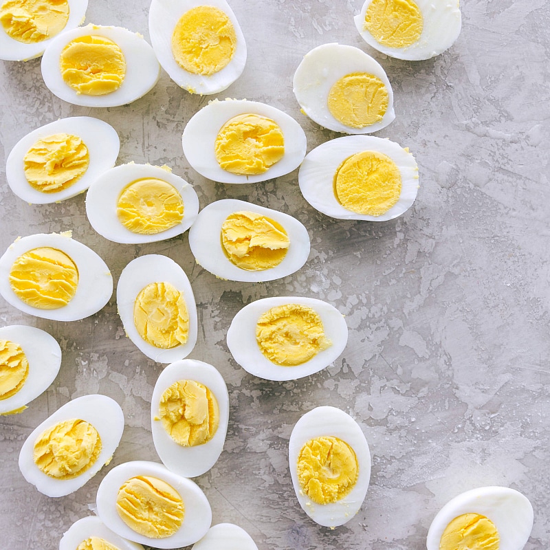 Several of the cooked eggs cut open, with their cooked yolks still in them.