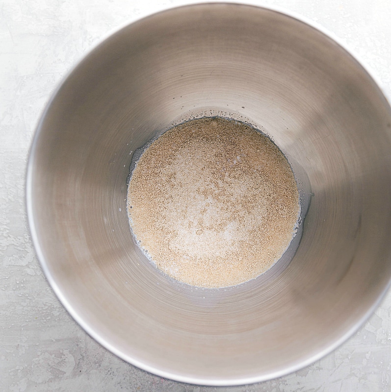 Image of the yeast and milk in the mixing bowl for this Dinner Roll recipe.
