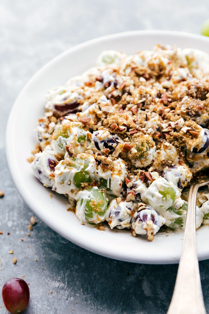 Grape Salad with a spoon in it, ready to serve.