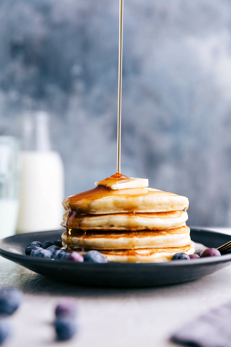 Image of syrup being poured over a stack of Greek Yogurt Pancakes.