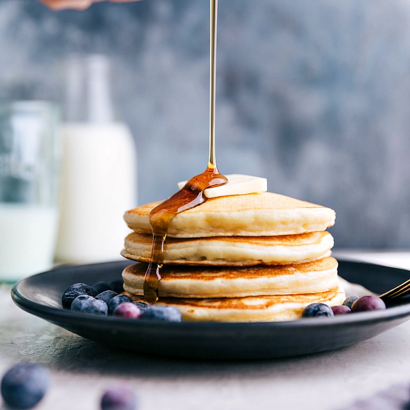 Syrup being poured over the Greek Yogurt Pancakes.