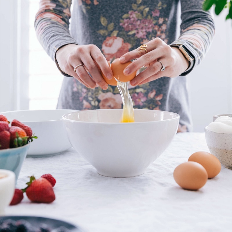 Egg being cracked into a bowl.