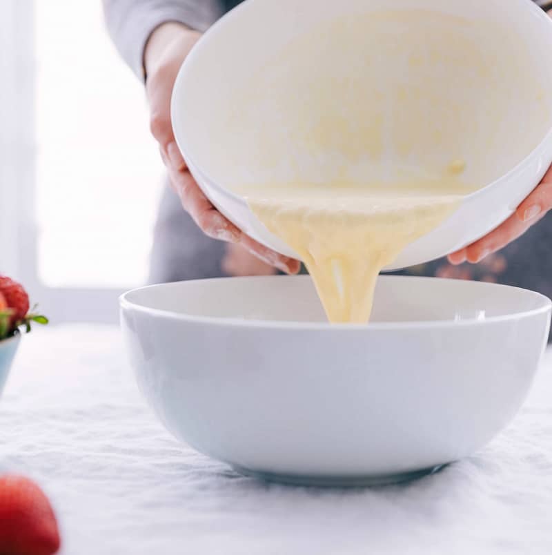 Wet ingredients being added to the dry for this Waffle Recipe.