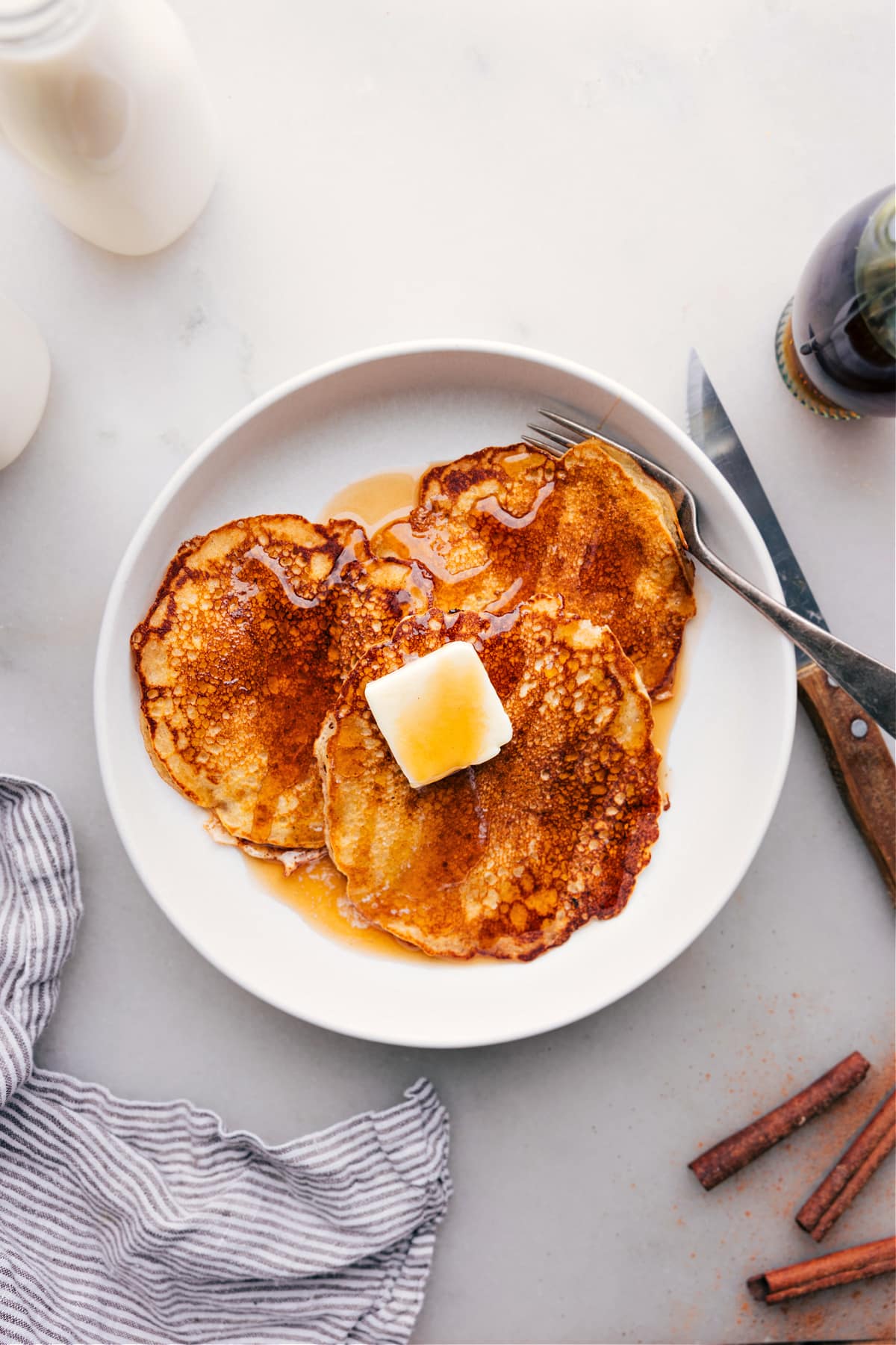 Delicious Stack of Pancakes Drizzled with Syrup on Plate