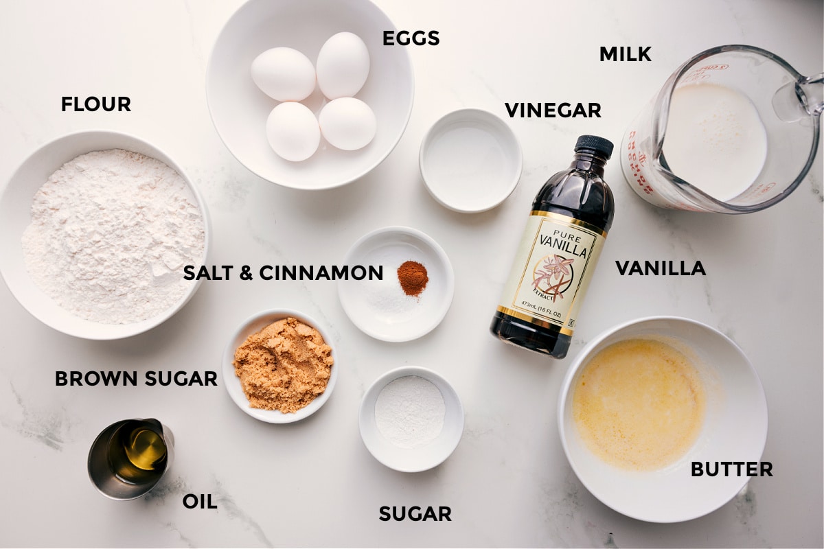 Ingredients In Waffle Recipe All the ingredients in this recipe prepped out for easy assembly including the flour, brown sugar, oil, eggs, salt, cinnamon, vinegar, sugar, vanilla, milk, and butter.
