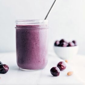 Ready-to-drink Cherry Smoothie with a straw in it.