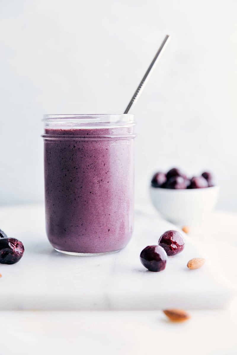 Image of the blended, ready-to-drink Cherry Smoothie with a straw in it.