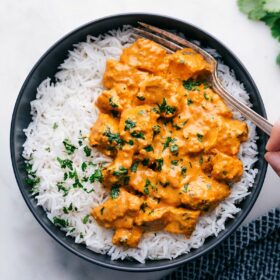 Bowl of Chicken Tikka Masala and rice with a fork digging in!
