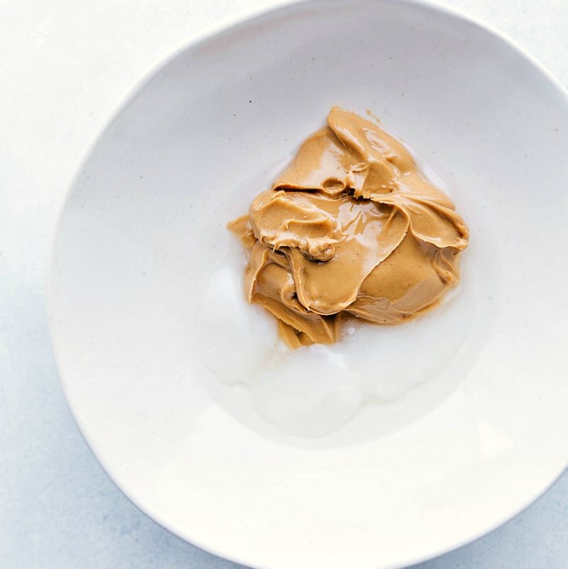 Peanut butter and coconut oil in a bowl.