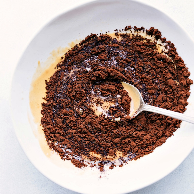 Image of the cocoa powder being added to a bowl for Fat Bombs.