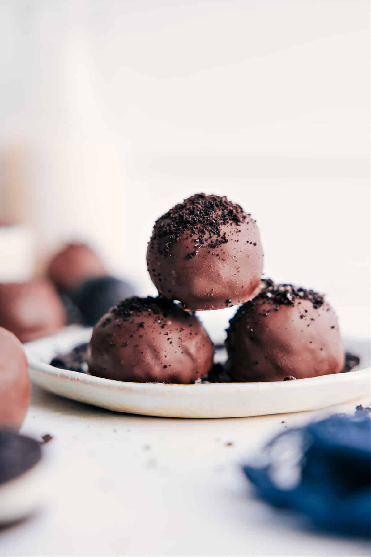 Simple And Delicious No Bake Oreo Truffles Oreo Truffles covered in chocolate with Oreo crumbs sprinkled on top.