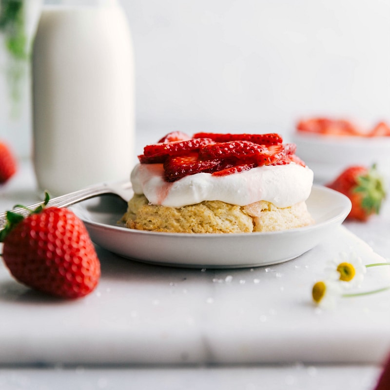 Image of the first layer of the Strawberry Shortcake with whipped cream and strawberries on top.