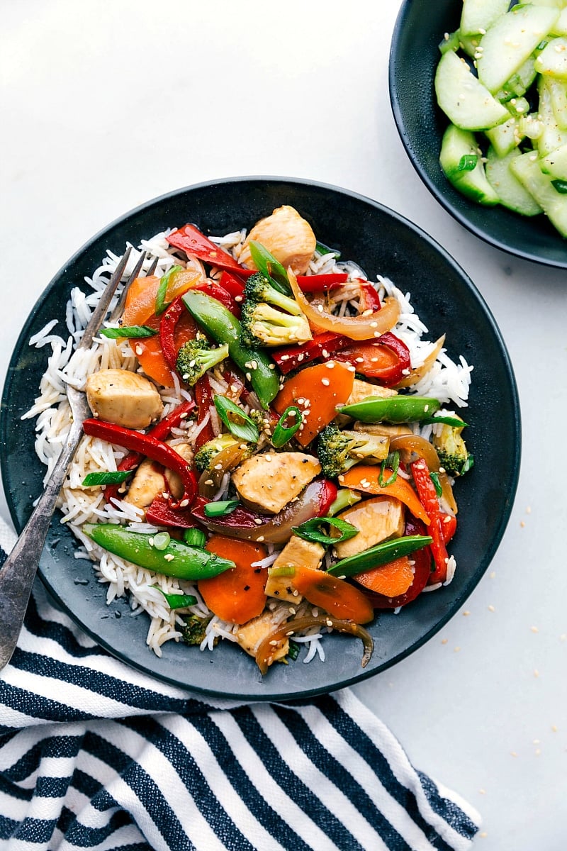 Flavor-packed stir fry chicken served in a bowl over a bed of rice, ready to be enjoyed.