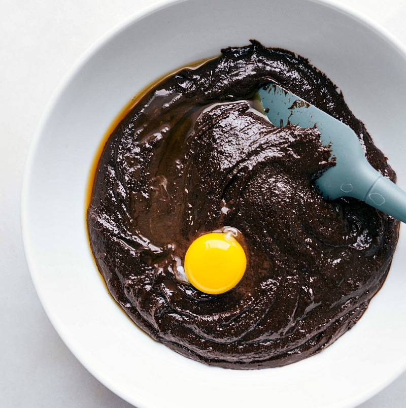 Wet ingredients being mixed together with an egg. 