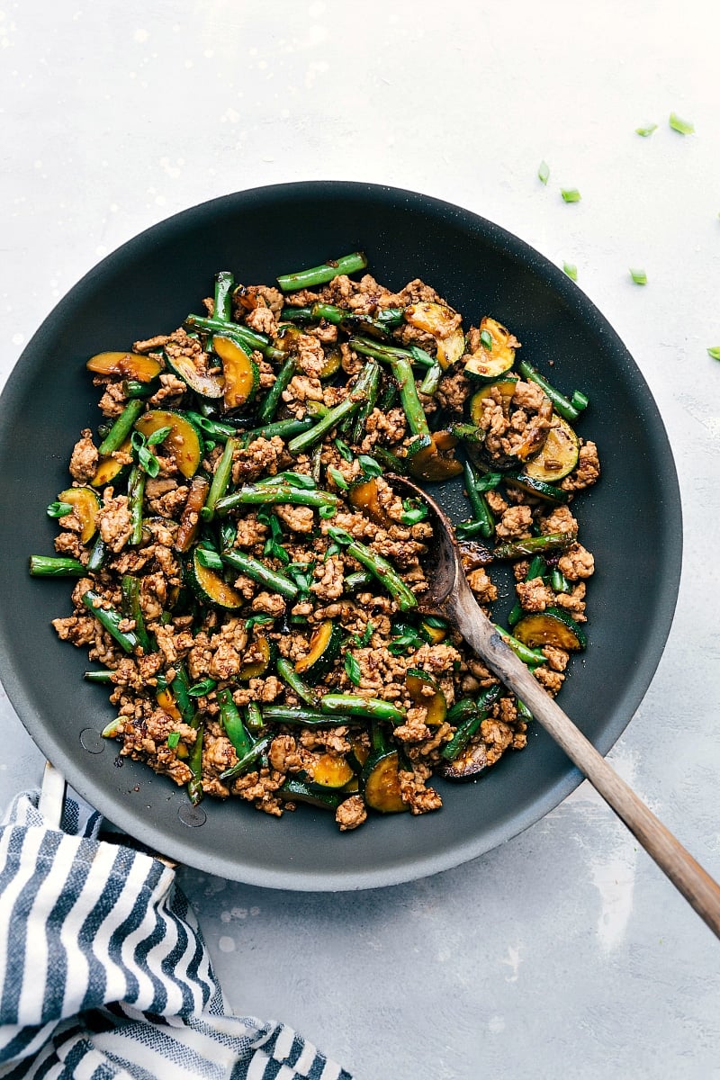 Pork stir fry sizzling in a skillet, seasoned to perfection and ready for a delightful meal.