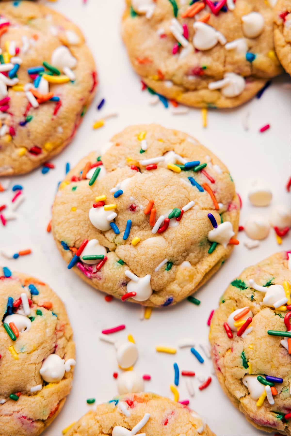 Cake batter cookies fresh out of the oven with extra sprinkles on top.