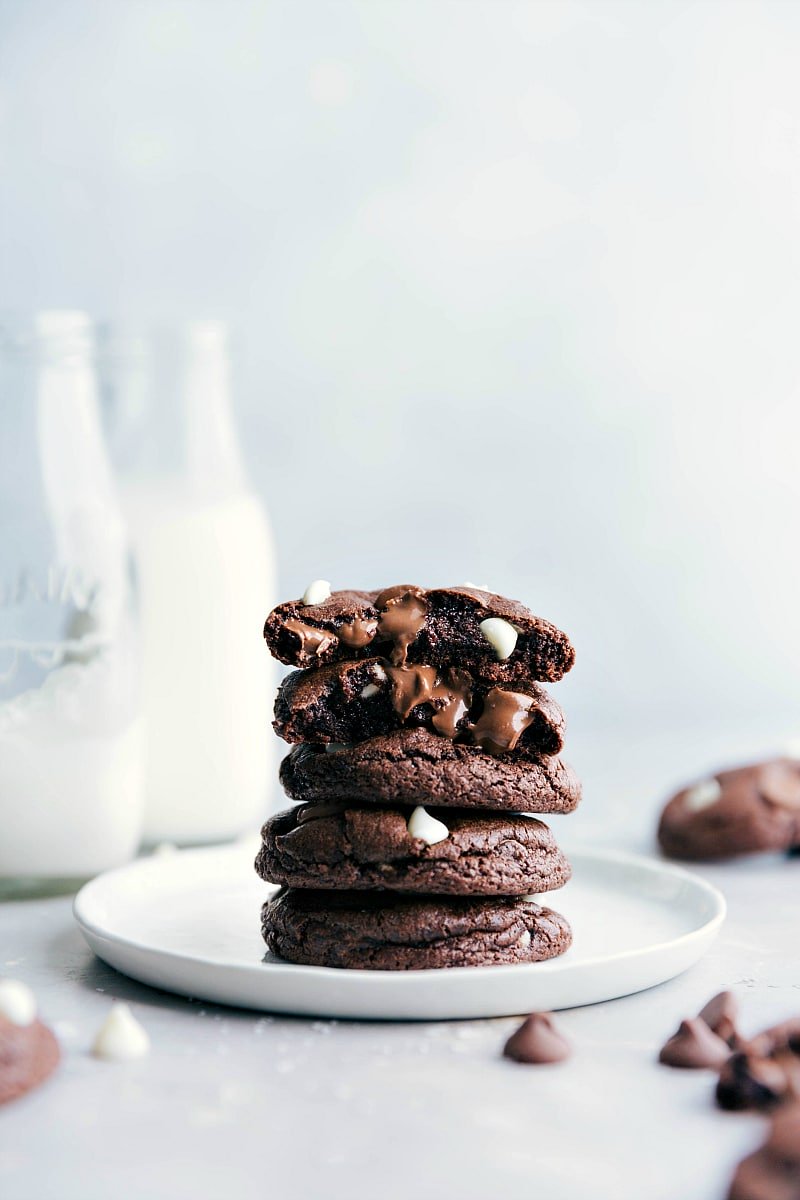 Image of a stack of Chocolate Cookies with one cookie split in half, showing the inside.