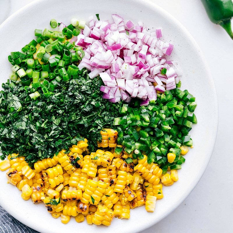 All the freshly chopped ingredients in a bowl, ready to be mixed together.