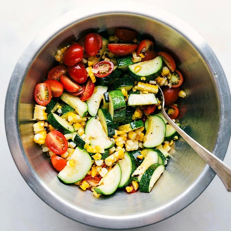 Image of the grilled corn-and-zucchini salad, mixed together in a bowl.