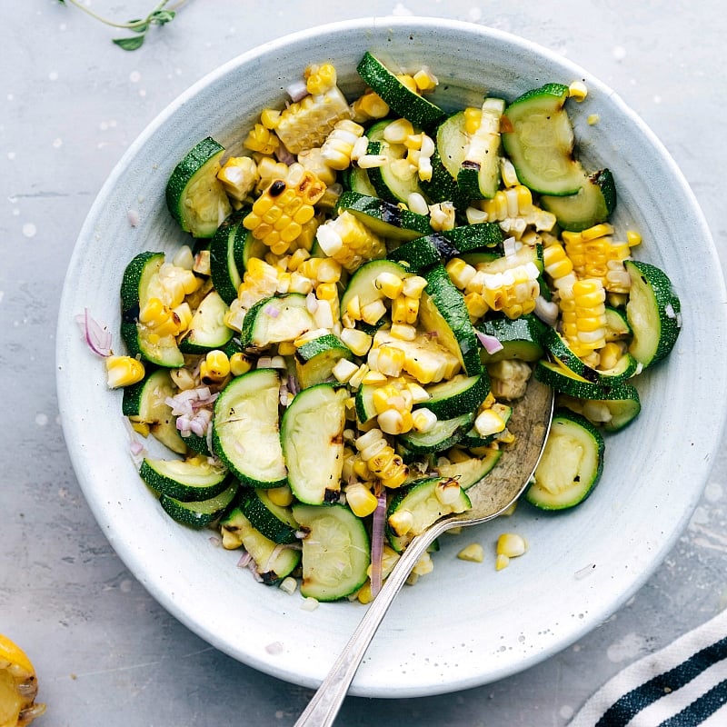 Overhead image of the grilled corn and zucchini salad that goes on the side of Greek Chicken.