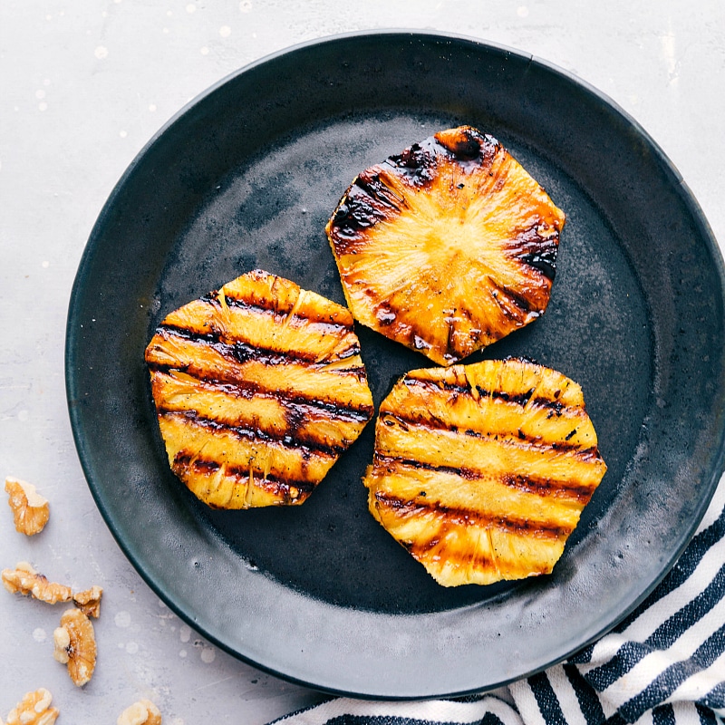 Grilled pineapple slices, just off the grill and still sizzling, ready to be incorporated into the mouthwatering dessert.