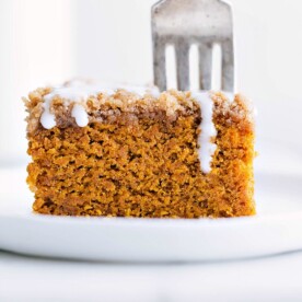 Delicious slice of pumpkin coffee cake with icing on top ready to be enjoyed.