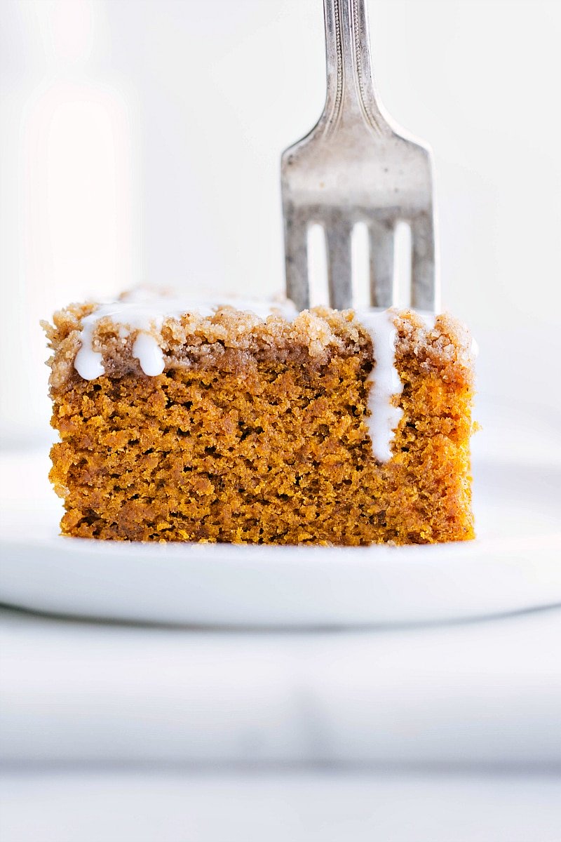 Delicious slice of pumpkin coffee cake with icing on top ready to be enjoyed.