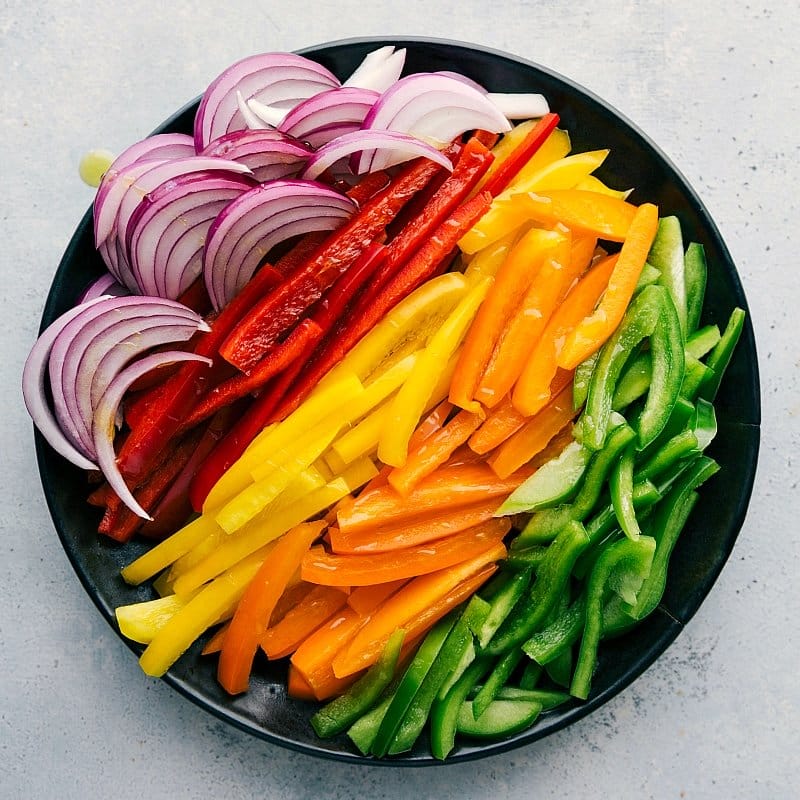 Process shot-- Image of all the sliced veggies that go in Shrimp Fajitas.